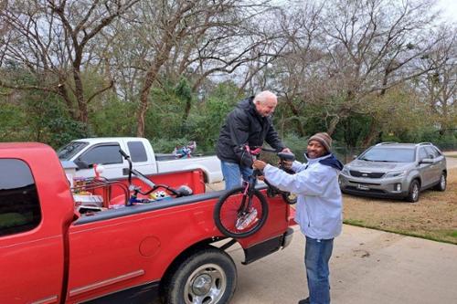 Servant Scholars Director gifts bike to community leader
